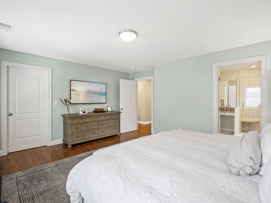 2 Mellen Street, Unit 2 Needham, MA 02494 - Photo 11 of 26 a bedroom with a bed and a flat screen tv