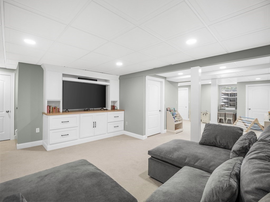 2 Mellen Street, Unit 2 Needham, MA 02494 - Photo 20 of 26 a living room with furniture and a flat screen tv