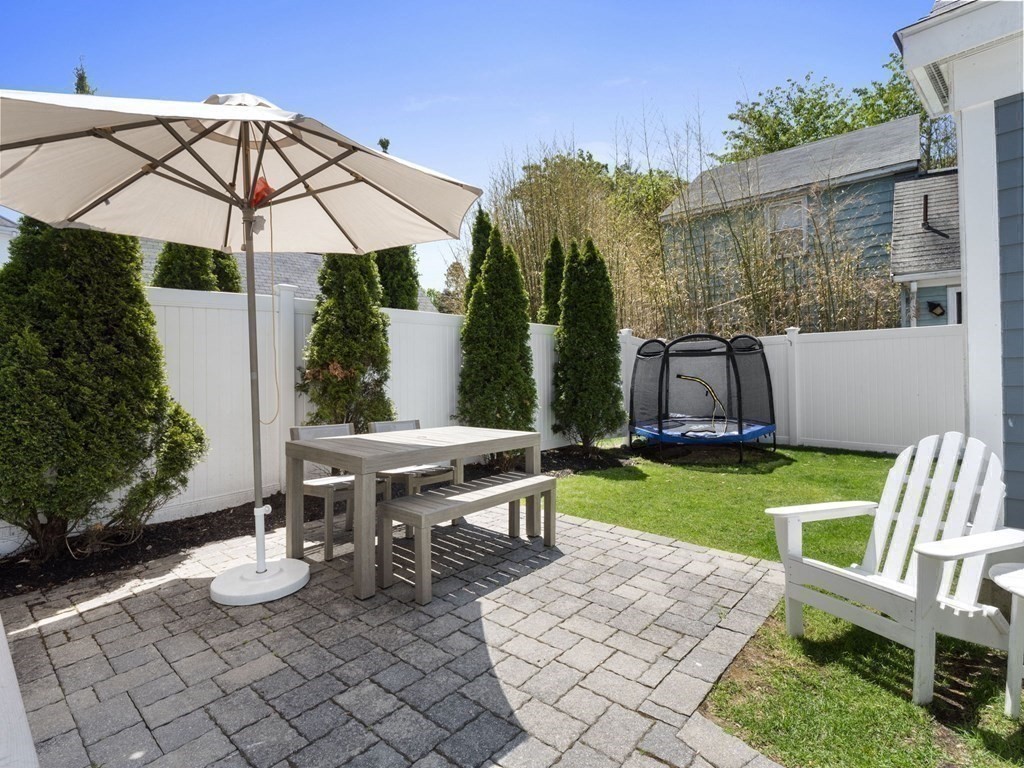 2 Mellen Street, Unit 2 Needham, MA 02494 - Photo 22 of 26 a view of a backyard with furniture and a garden