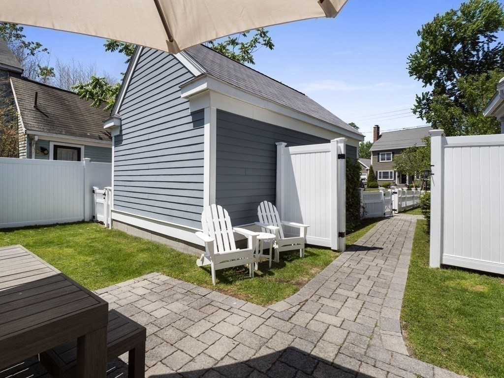 2 Mellen Street, Unit 2 Needham, MA 02494 - Photo 23 of 26 a view of a patio with table and chairs with wooden fence
