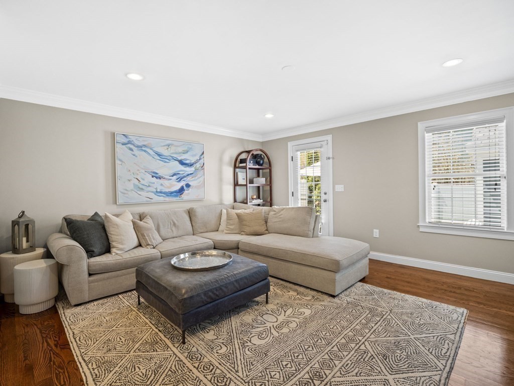 2 Mellen Street, Unit 2 Needham, MA 02494 - Photo 3 of 26 a living room with furniture and painting on the wall