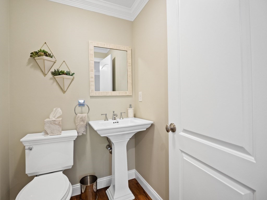 2 Mellen Street, Unit 2 Needham, MA 02494 - Photo 9 of 26 a bathroom with a toilet sink and mirror
