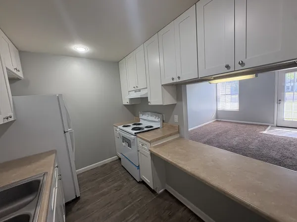 a kitchen with a sink stove and cabinets