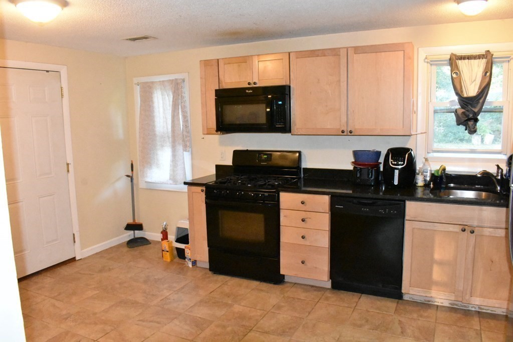 15 Rainbow Circle Middleboro, MA 02346 - Photo 11 of 22 a kitchen with stainless steel appliances granite countertop a stove a sink and a microwave