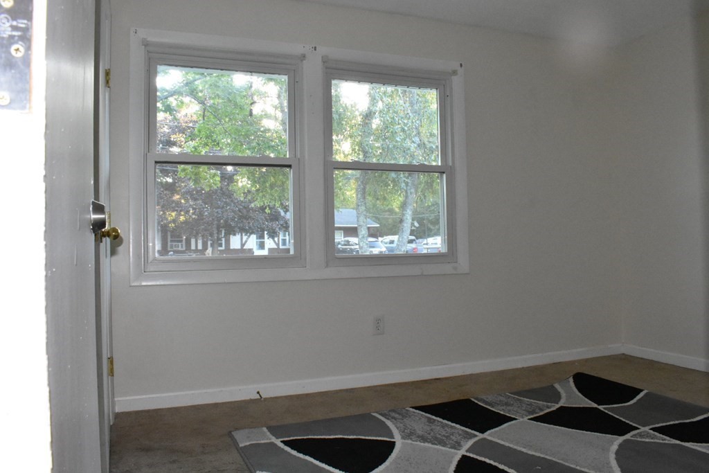 15 Rainbow Circle Middleboro, MA 02346 - Photo 16 of 22 wooden floor in an empty room with a window