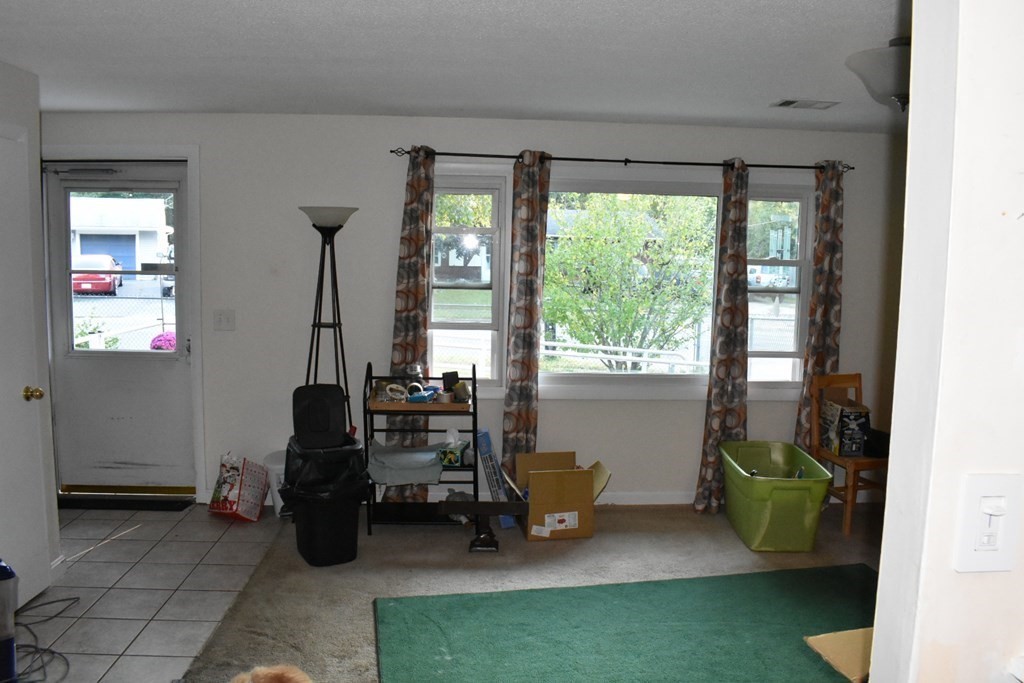 15 Rainbow Circle Middleboro, MA 02346 - Photo 8 of 22 a living room with furniture and a floor to ceiling window