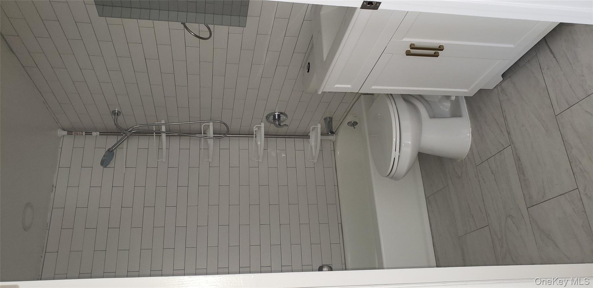 184-11 144th Road Queens, NY 11413 - Photo 15 of 16 a bathroom with a toilet a sink and bathtub