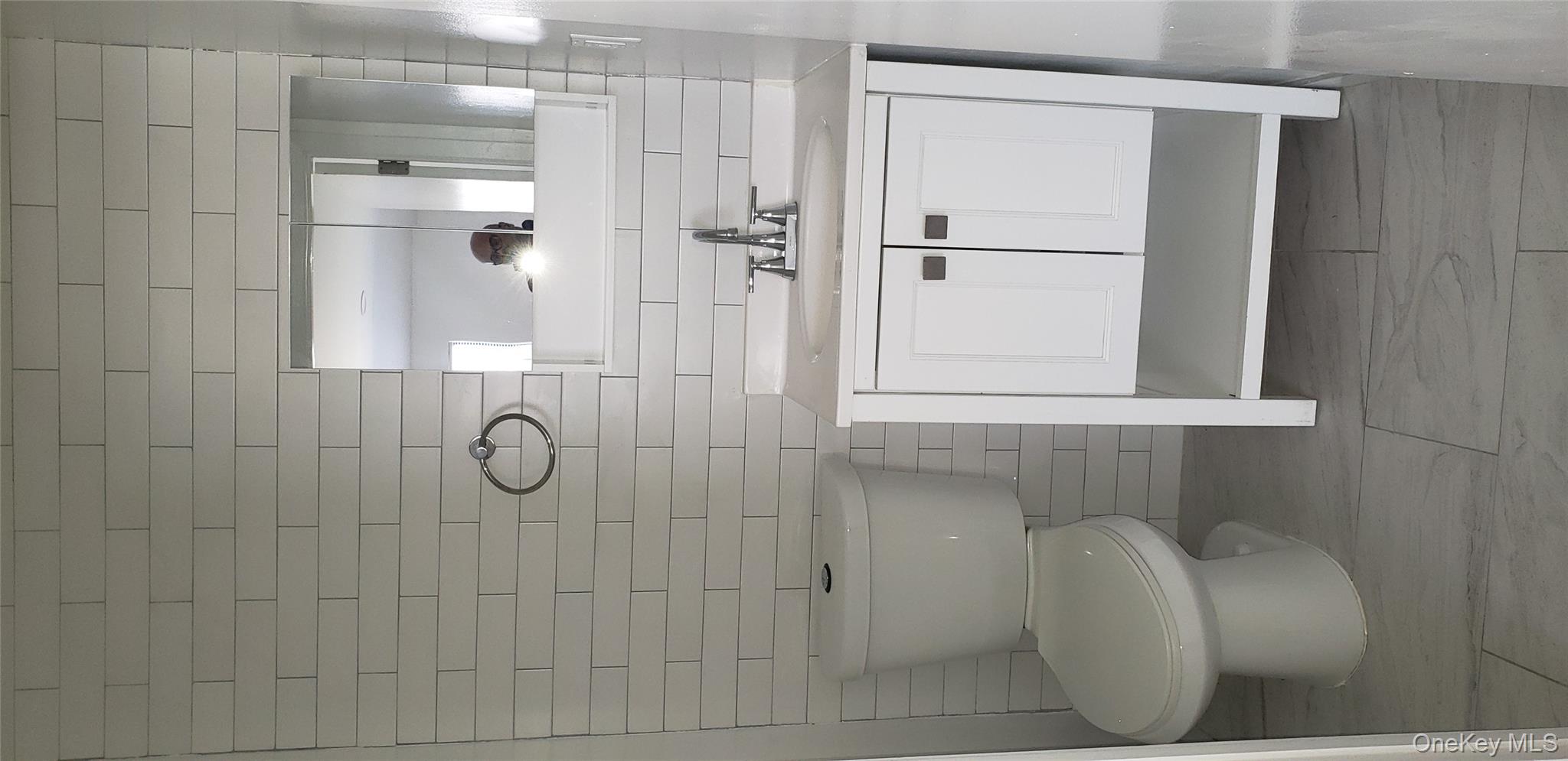 184-11 144th Road Queens, NY 11413 - Photo 16 of 16 a bathroom with a toilet a sink and mirror