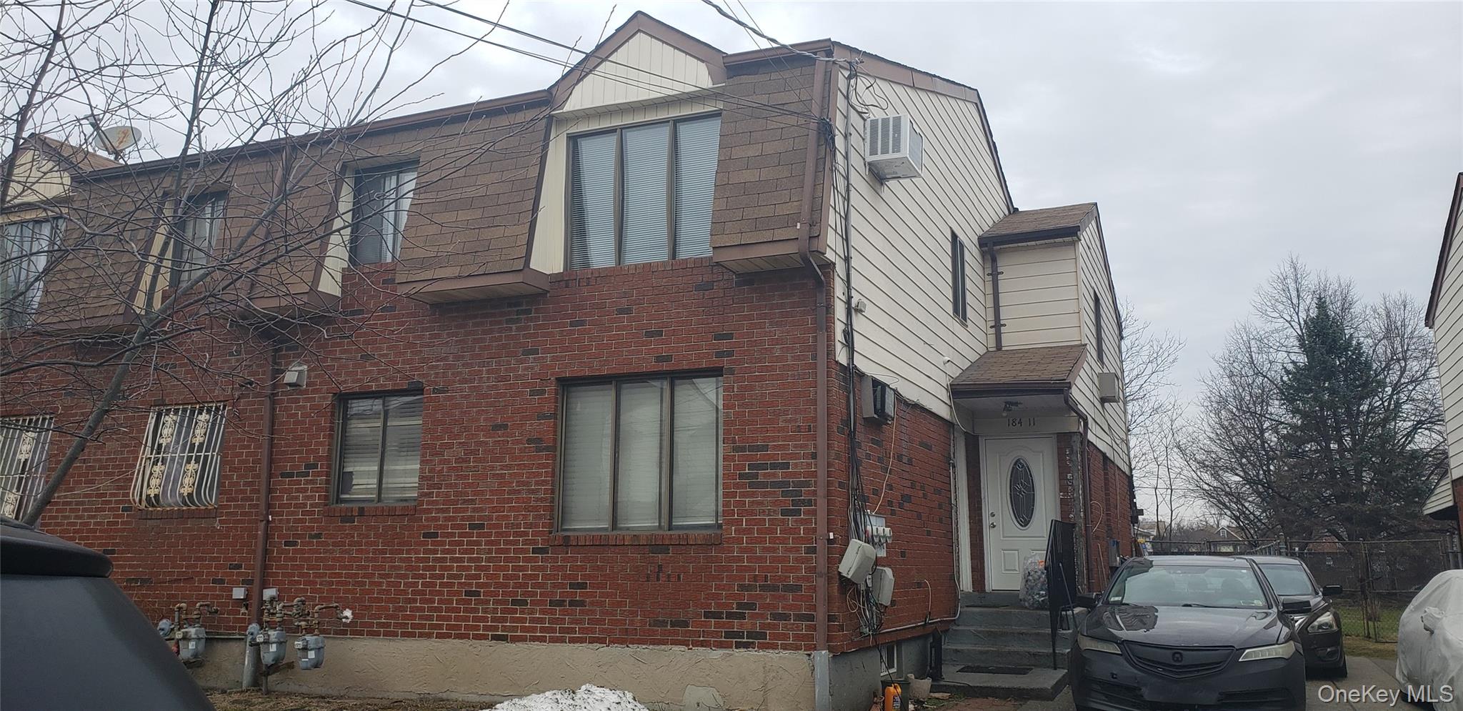 184-11 144th Road Queens, NY 11413 - Photo 2 of 16 a front view of a house with parking space
