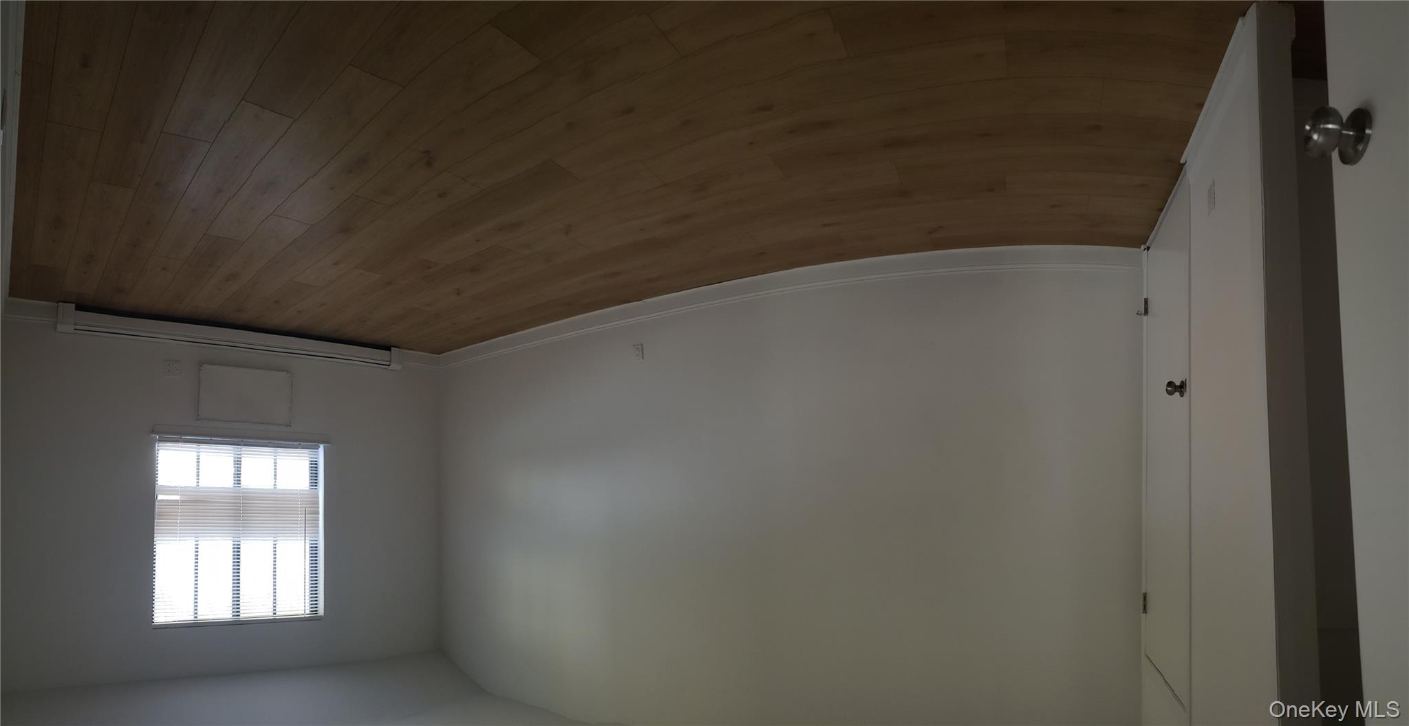 184-11 144th Road Queens, NY 11413 - Photo 9 of 16 an empty room with wooden floor and windows