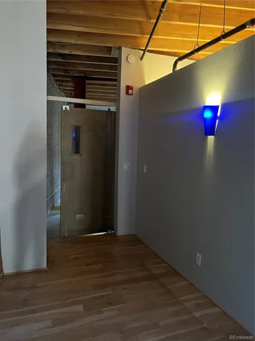 a view of a room with wooden floor