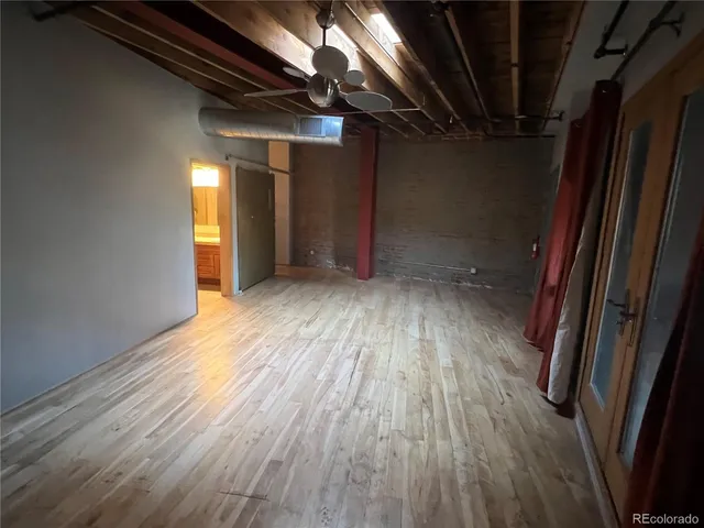 a view of empty room with wooden floor