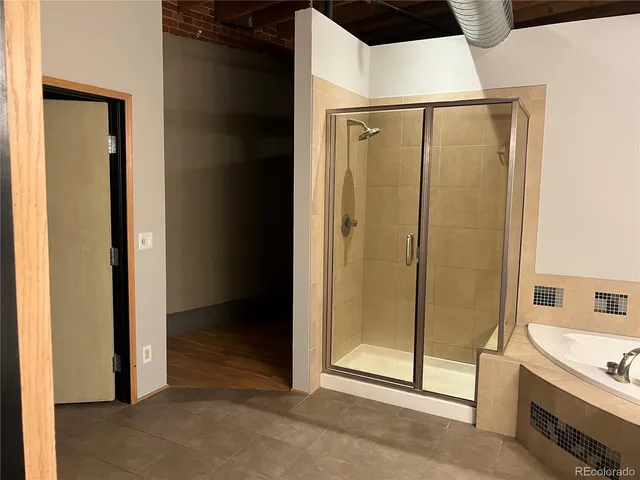 a bathroom with a shower and a tub