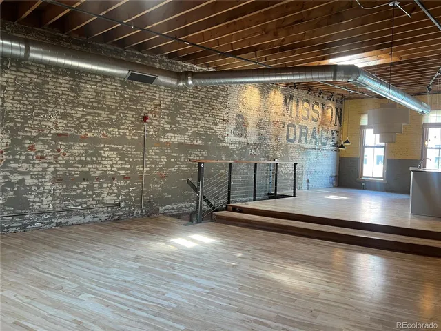 a view of water heater room with wooden floor