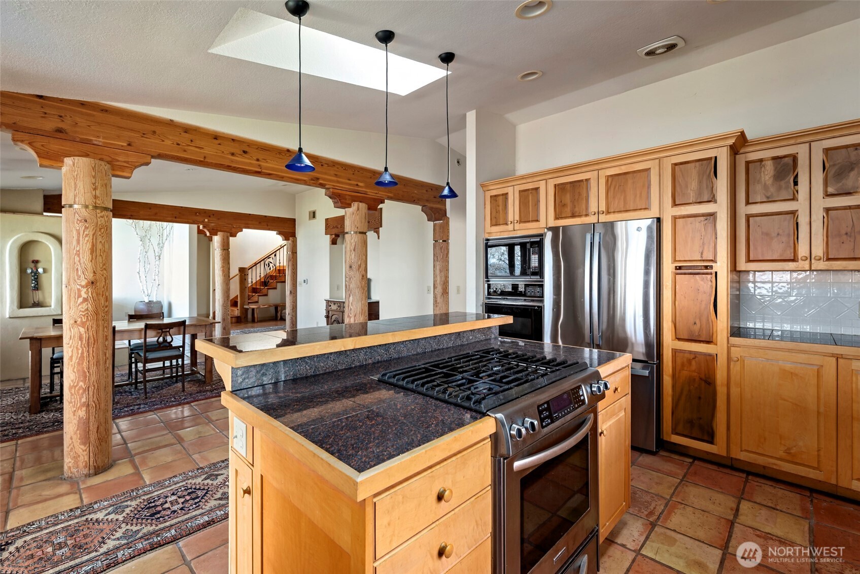 5477 Wilkinson Road Langley, WA 98260 - Photo 20 of 40 a kitchen with stainless steel appliances granite countertop a stove a refrigerator and a sink