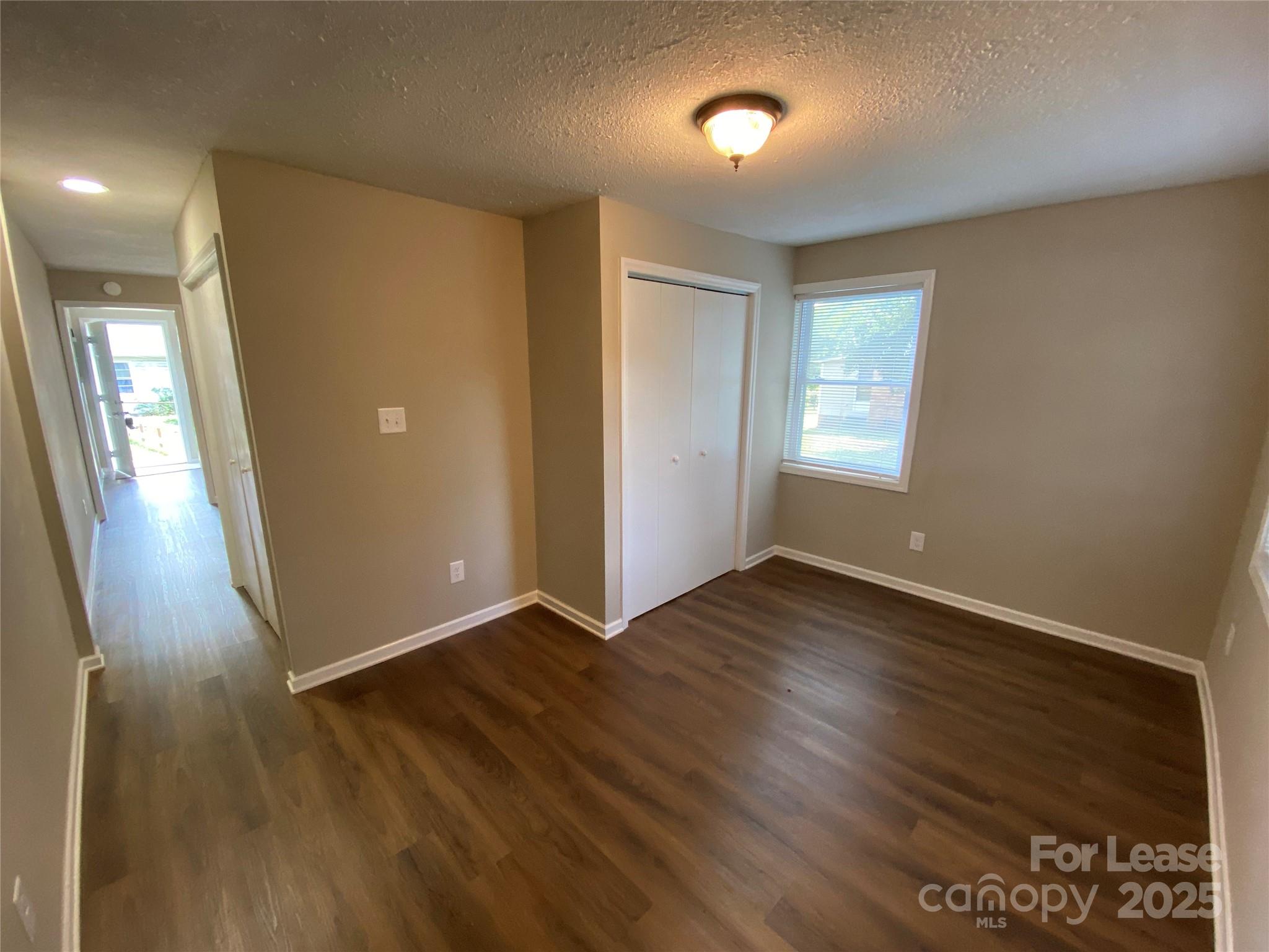 1625 Armstrong Ford Road, Unit B Belmont, NC 28012 - Photo 2 of 5 an empty room with wooden floor and windows