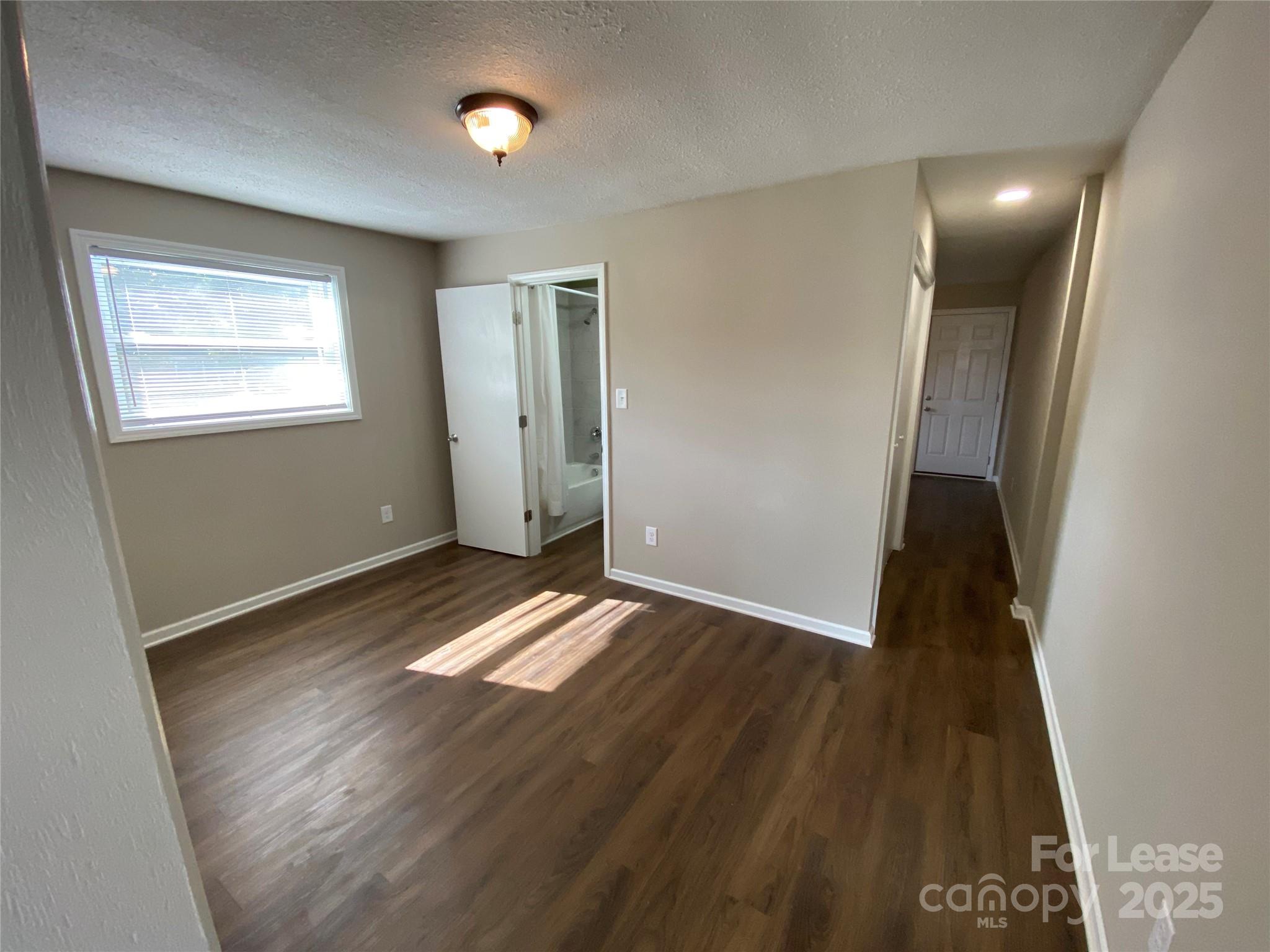 1625 Armstrong Ford Road, Unit B Belmont, NC 28012 - Photo 4 of 5 an empty room with wooden floor and windows