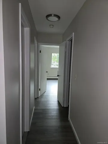 a view of hallway with wooden floor