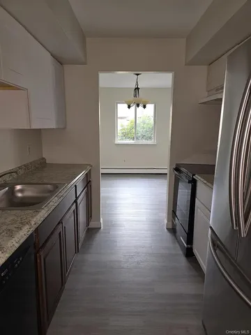 an empty room with wooden floor and a window