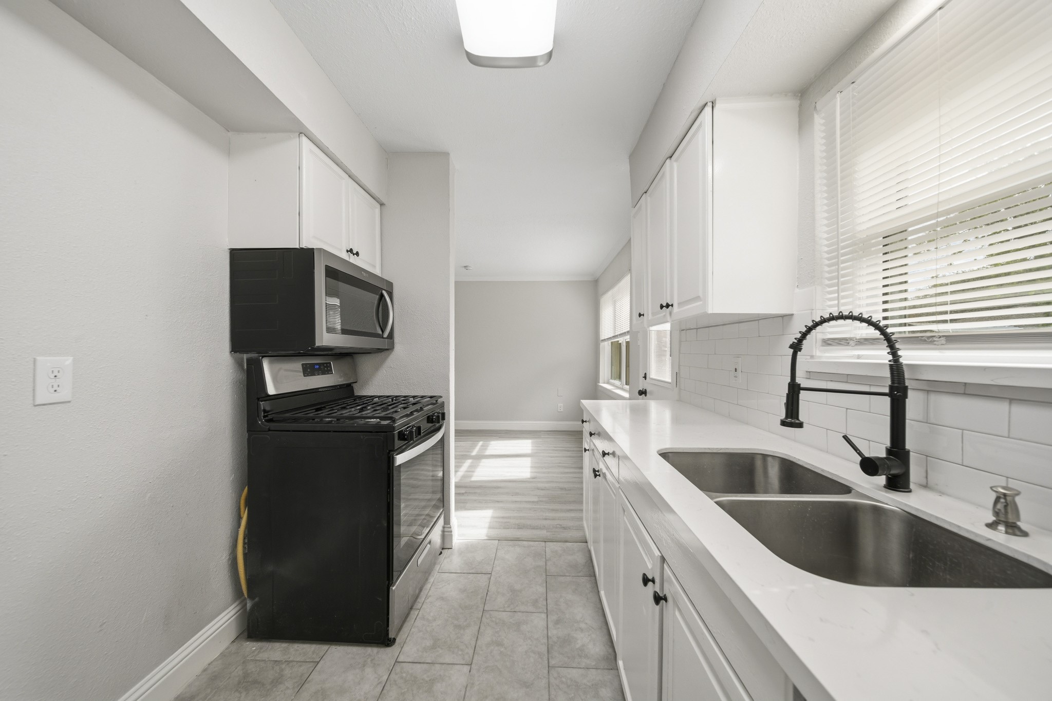 5347 Castlecreek Lane Houston, TX 77053 - Photo 11 of 20 a kitchen with a sink and a refrigerator