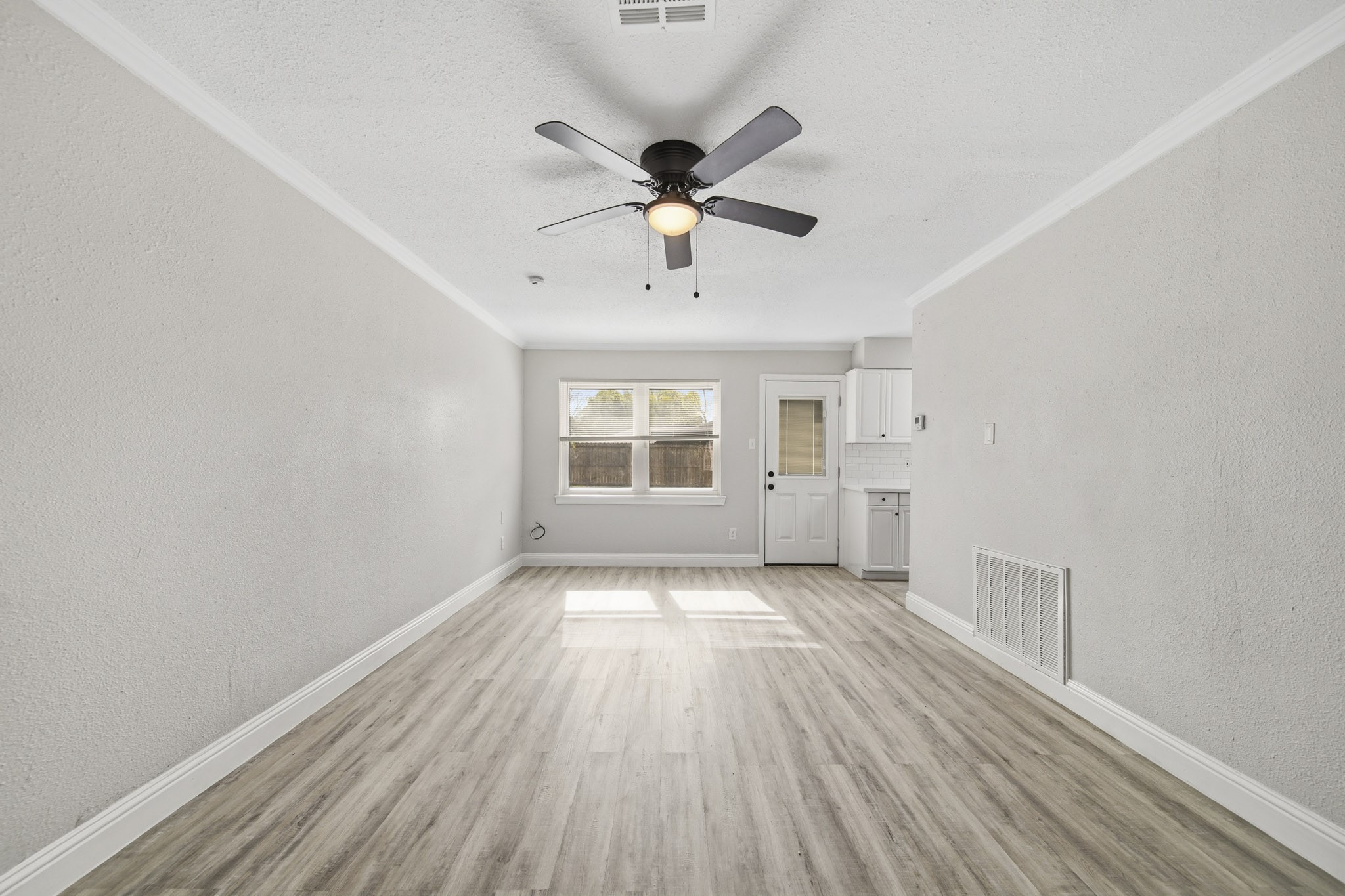 5347 Castlecreek Lane Houston, TX 77053 - Photo 7 of 20 a view of an empty room with window and wooden floor