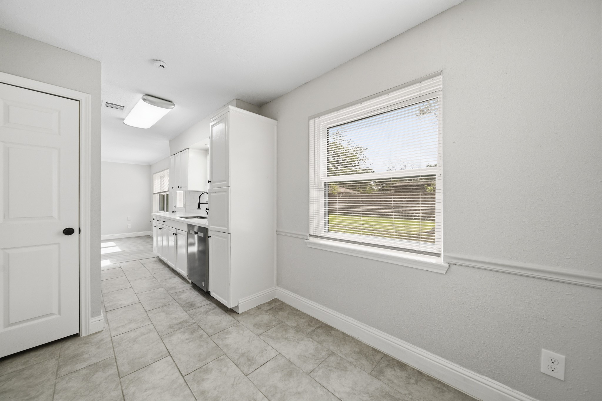 5347 Castlecreek Lane Houston, TX 77053 - Photo 10 of 20 a view of a kitchen with a white cabinet and a stove top oven