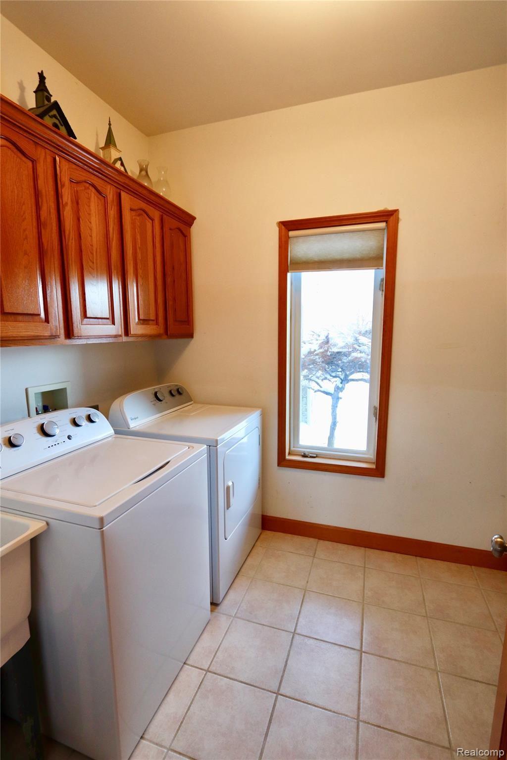 7751 Munsell Road Howell, MI 48843 - Photo 47 of 60 Large laundry room with laundry sink and ceramic floor.