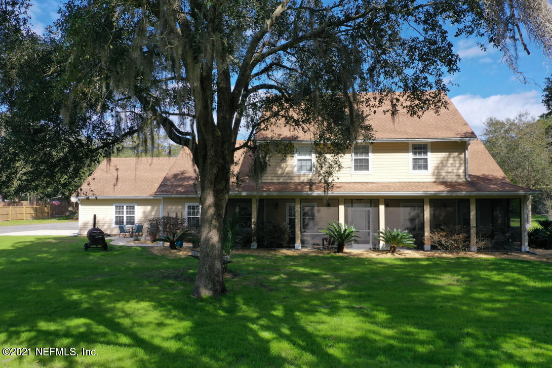 97002 Po Folks Way Yulee, FL 32097 - Photo 1 of 57 a front view of a house with a yard and green space