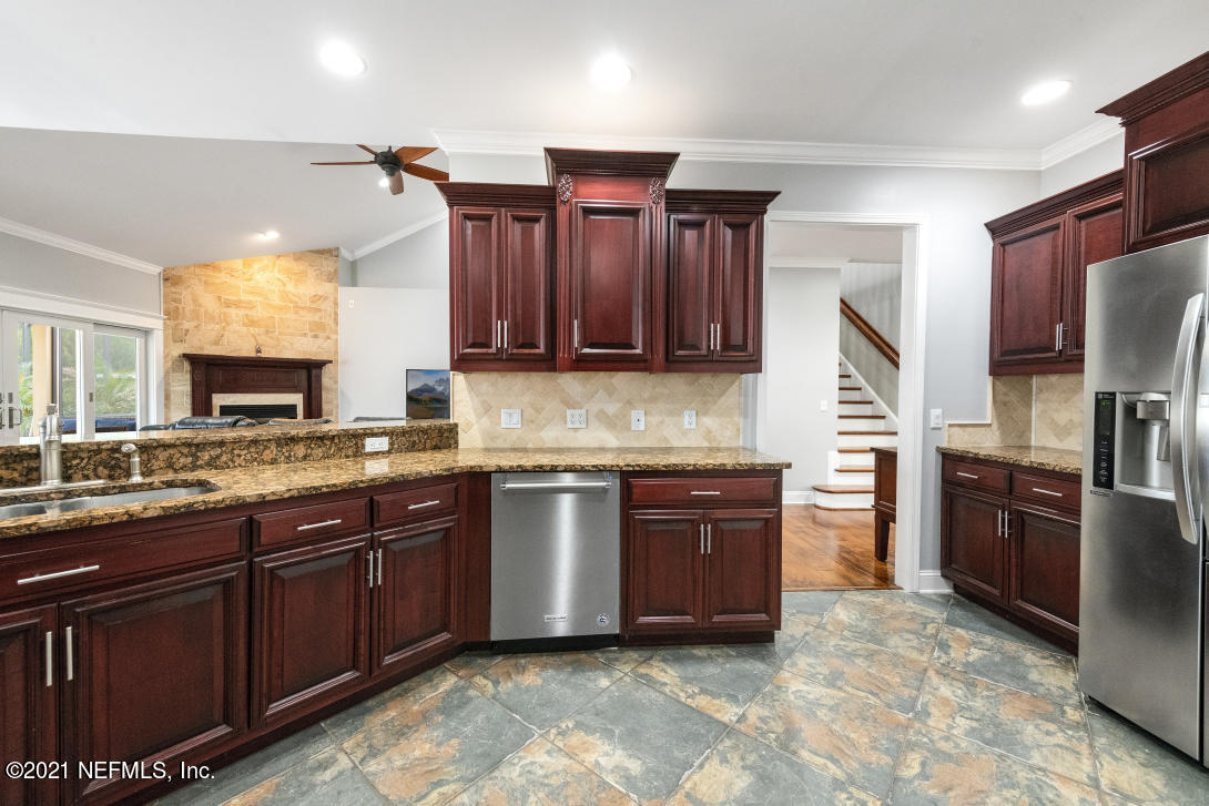 97002 Po Folks Way Yulee, FL 32097 - Photo 12 of 57 a kitchen with stainless steel appliances granite countertop a sink stove and refrigerator