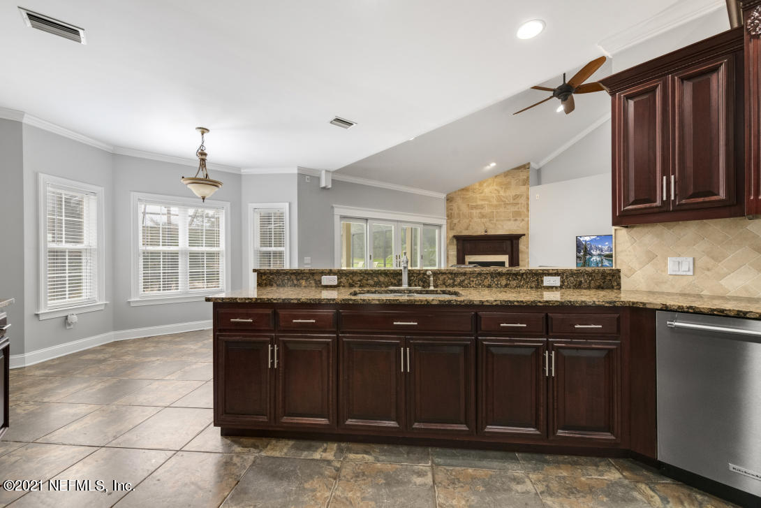 97002 Po Folks Way Yulee, FL 32097 - Photo 15 of 57 a kitchen with a sink and wooden cabinets