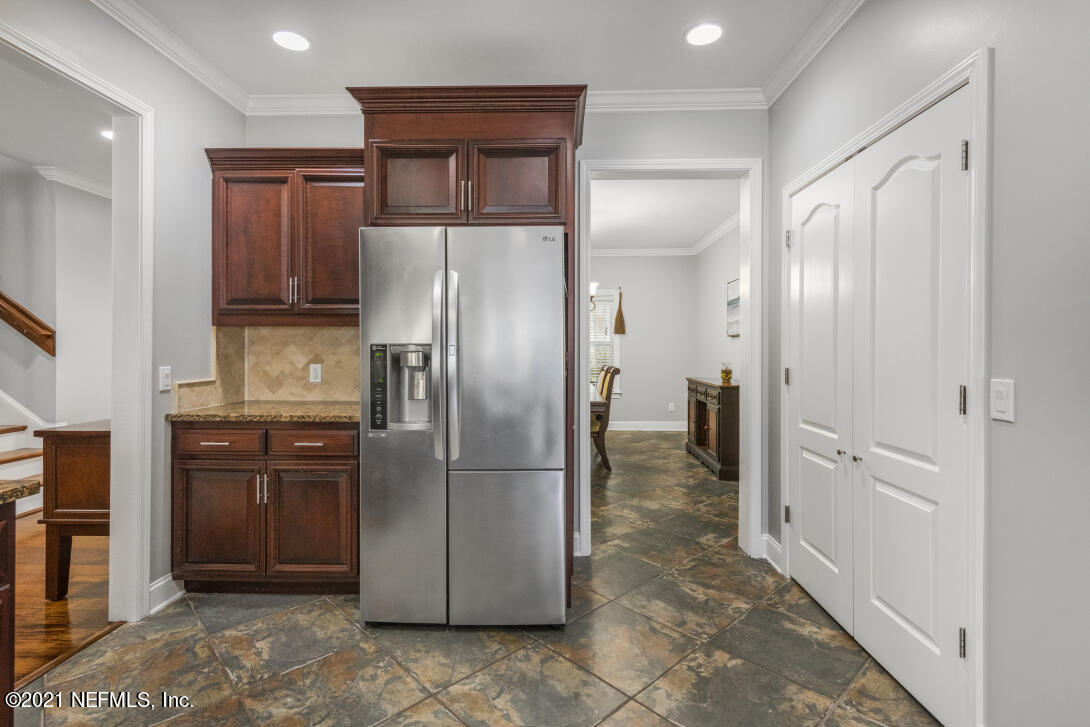 97002 Po Folks Way Yulee, FL 32097 - Photo 17 of 57 a kitchen with stainless steel appliances granite countertop a refrigerator and a sink