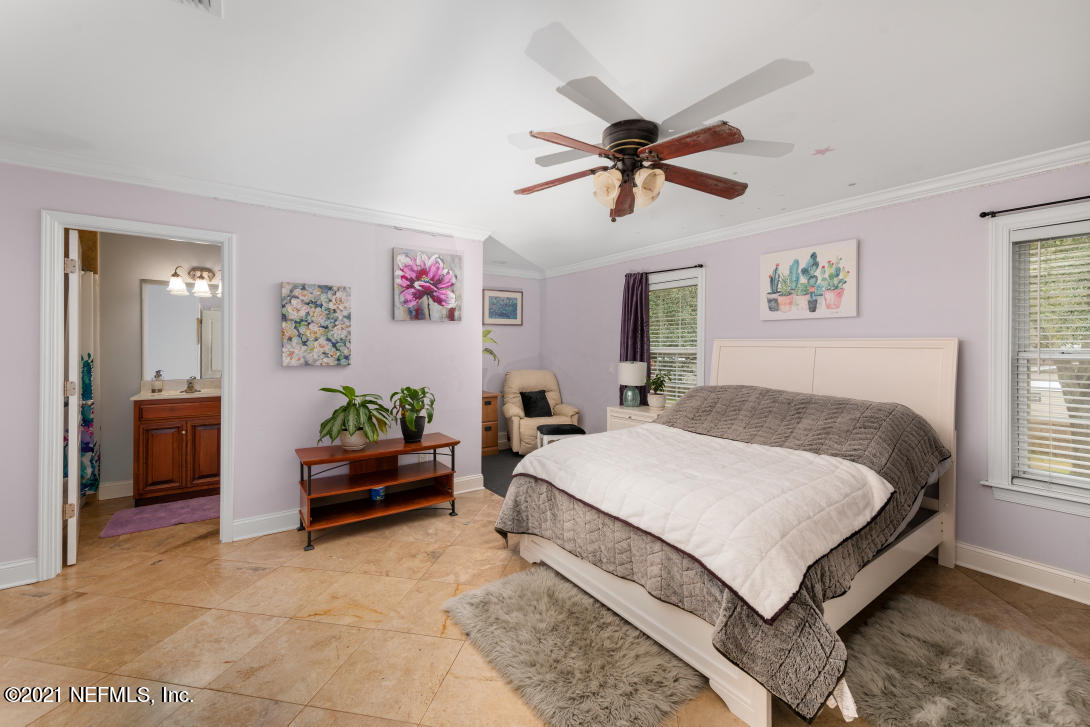 97002 Po Folks Way Yulee, FL 32097 - Photo 28 of 57 a spacious bedroom with a bed and a chandelier