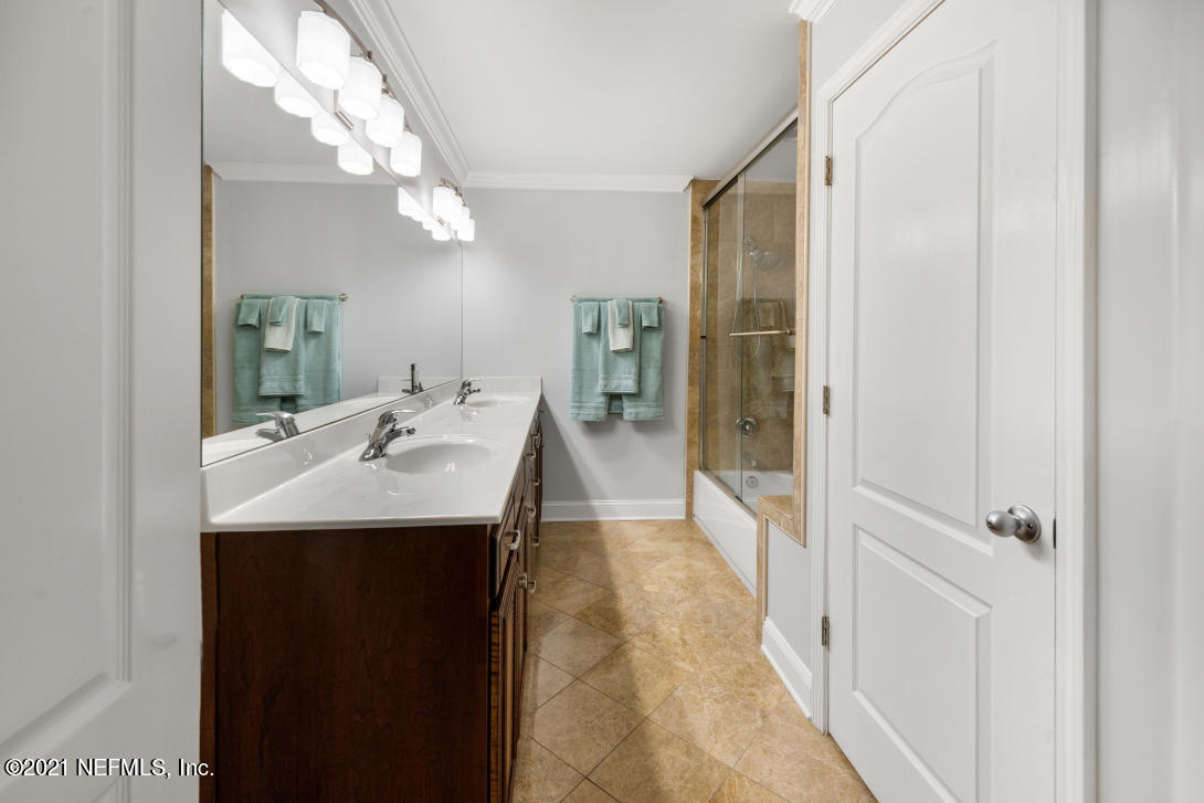 97002 Po Folks Way Yulee, FL 32097 - Photo 29 of 57 a en suite bathroom with a sink a mirror and a shower