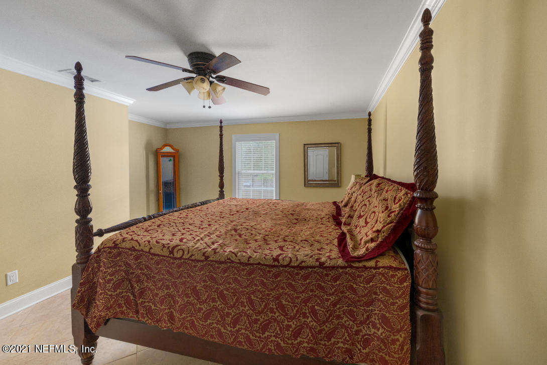 97002 Po Folks Way Yulee, FL 32097 - Photo 30 of 57 a bedroom with a bed dresser and a window