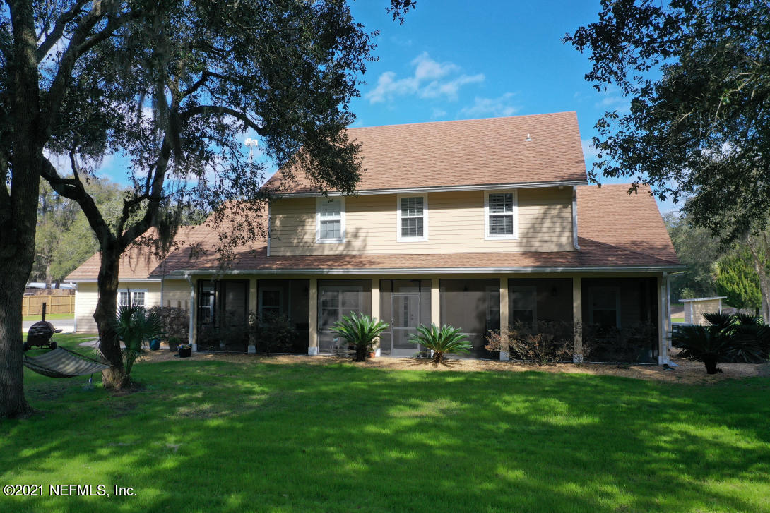 97002 Po Folks Way Yulee, FL 32097 - Photo 3 of 57 a front view of a house with a garden and porch
