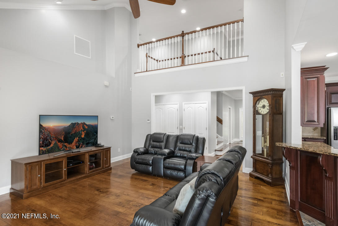 97002 Po Folks Way Yulee, FL 32097 - Photo 33 of 57 a living room with furniture a flat screen tv and kitchen view