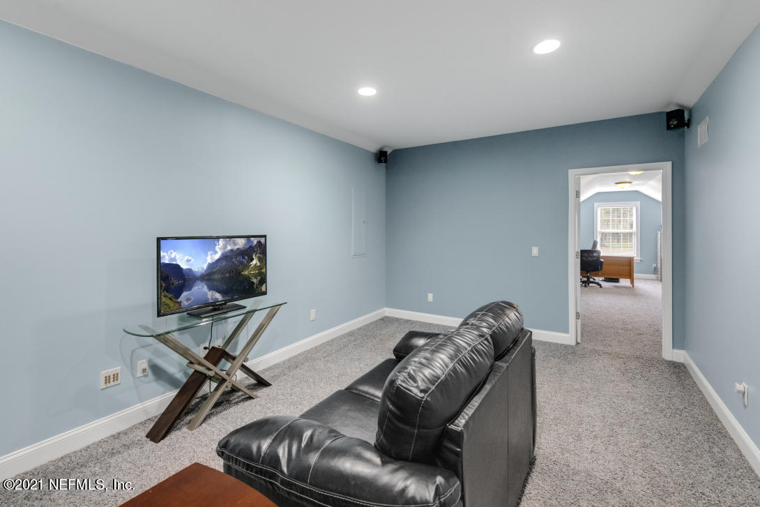 97002 Po Folks Way Yulee, FL 32097 - Photo 46 of 57 a living room with furniture and a flat screen tv