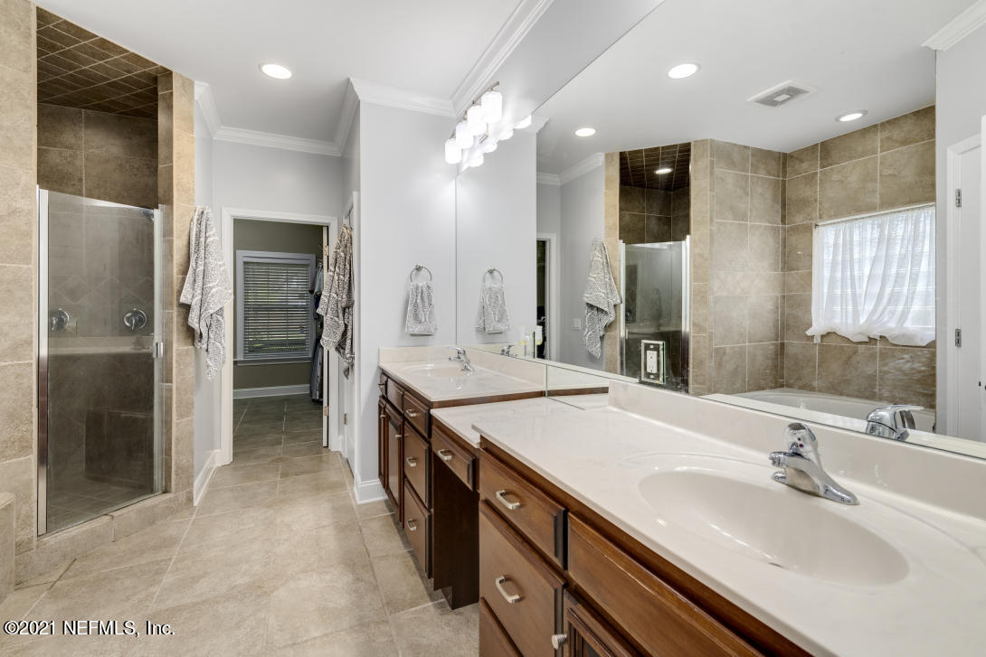 97002 Po Folks Way Yulee, FL 32097 - Photo 47 of 57 a spacious bathroom with a double vanity sink mirror and shower