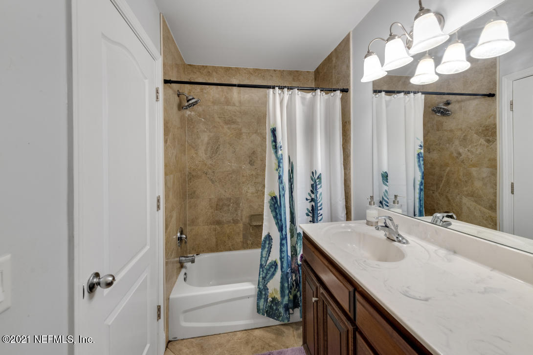 97002 Po Folks Way Yulee, FL 32097 - Photo 51 of 57 a bathroom with a granite countertop sink a mirror and a bathtub