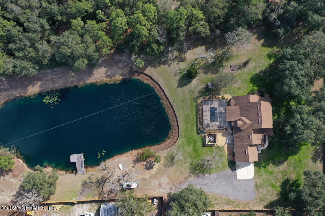 97002 Po Folks Way Yulee, FL 32097 - Photo 56 of 57 an aerial view of a house with outdoor space and a lake view