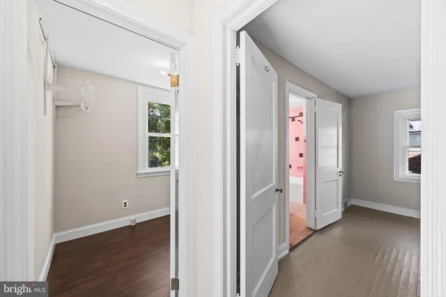 a view of a hallway with wooden floor