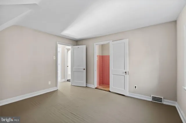 a view of empty room with wooden ceiling