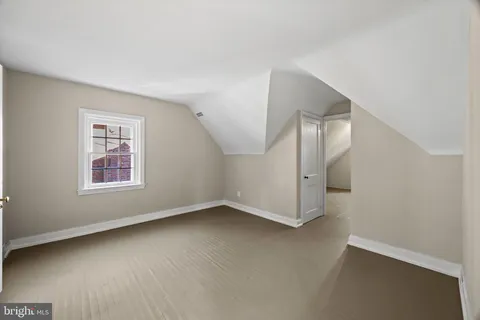 a view of a yard with a large tree and wooden fence