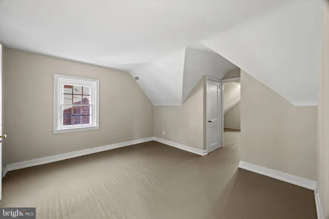 a view of a yard with a large tree and wooden fence