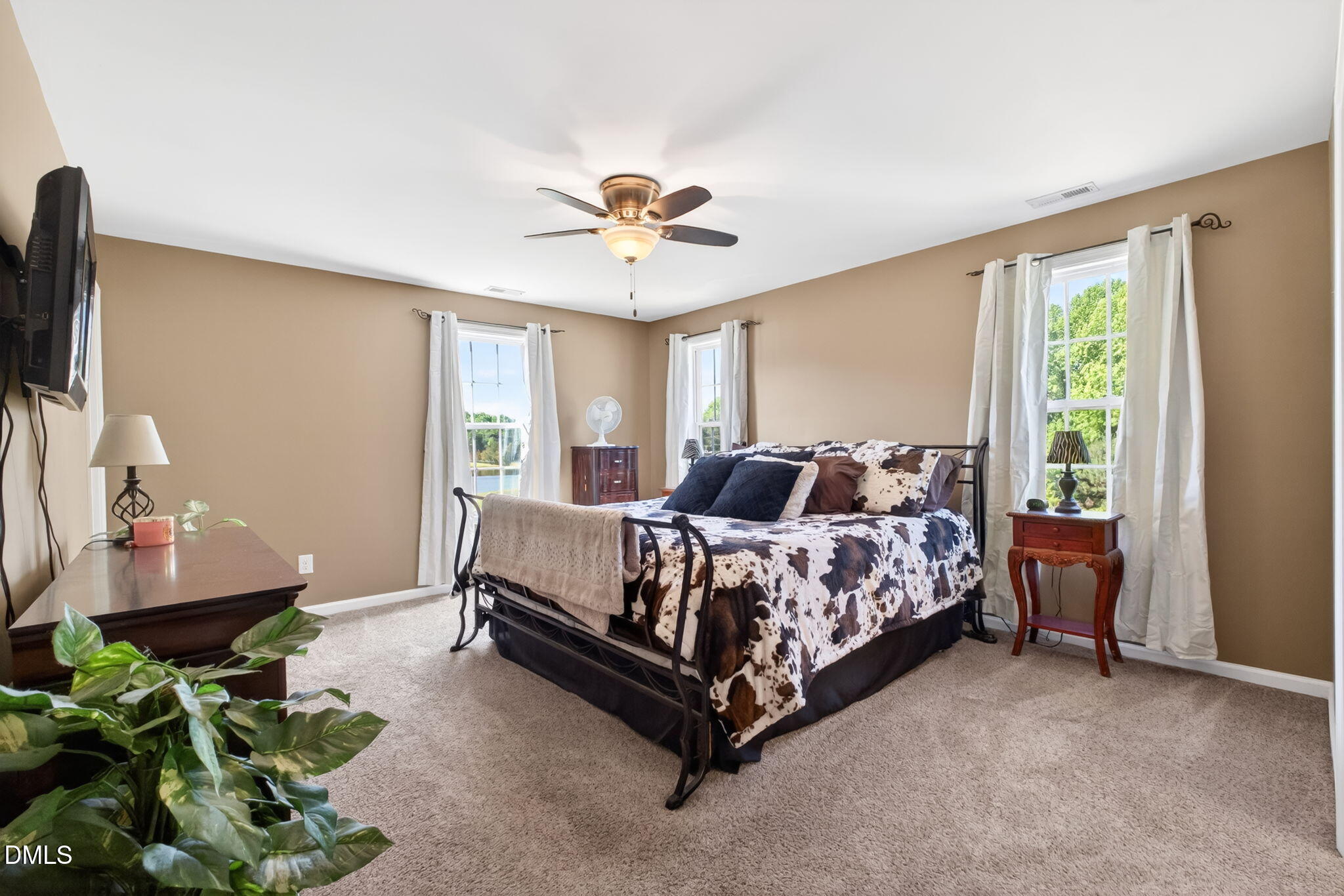 923 White Memorial Church Road Willow Spring, NC 27592 - Photo 24 of 46 a bed room with a bed and a chandelier