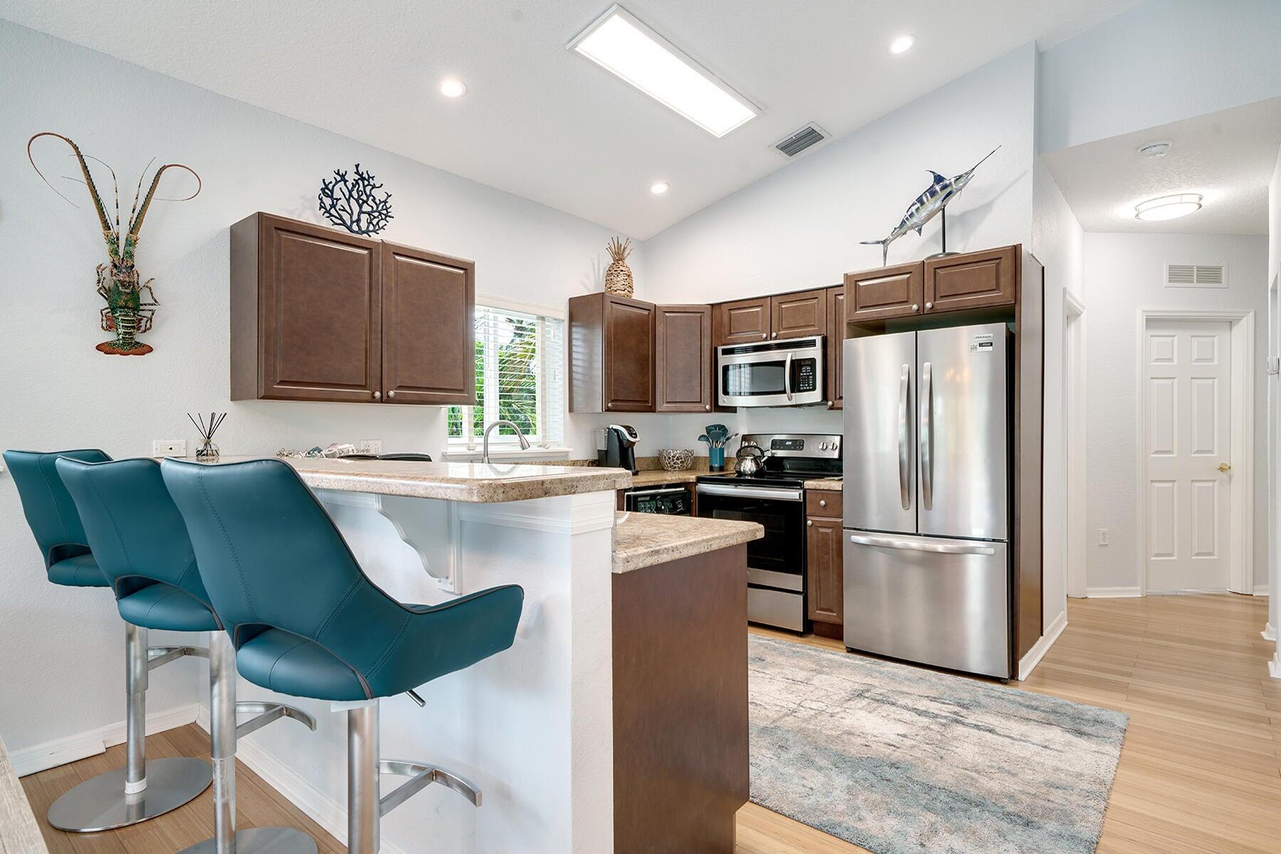191 Carroll Street Islamorada, FL 33036 - Photo 20 of 40 a kitchen with kitchen island stainless steel appliances a refrigerator stove a sink and a microwave