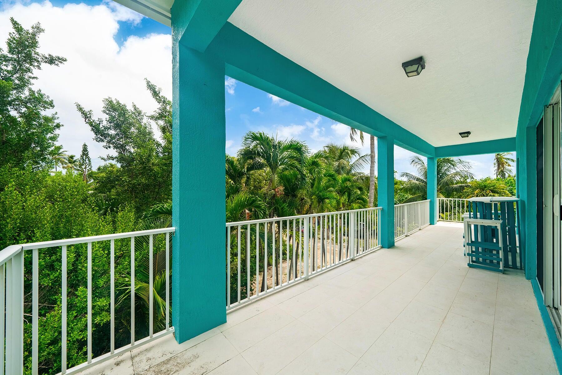 191 Carroll Street Islamorada, FL 33036 - Photo 31 of 40 a balcony with trees in front of it