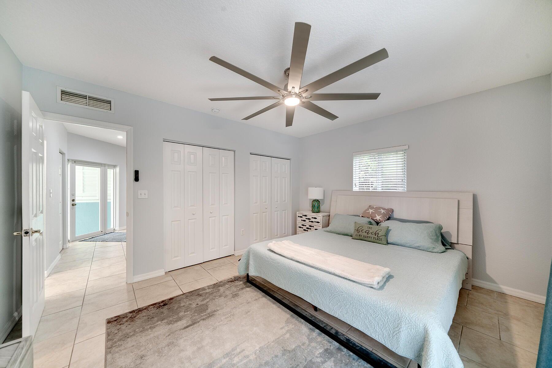 191 Carroll Street Islamorada, FL 33036 - Photo 8 of 40 a bedroom with a bed and a chandelier