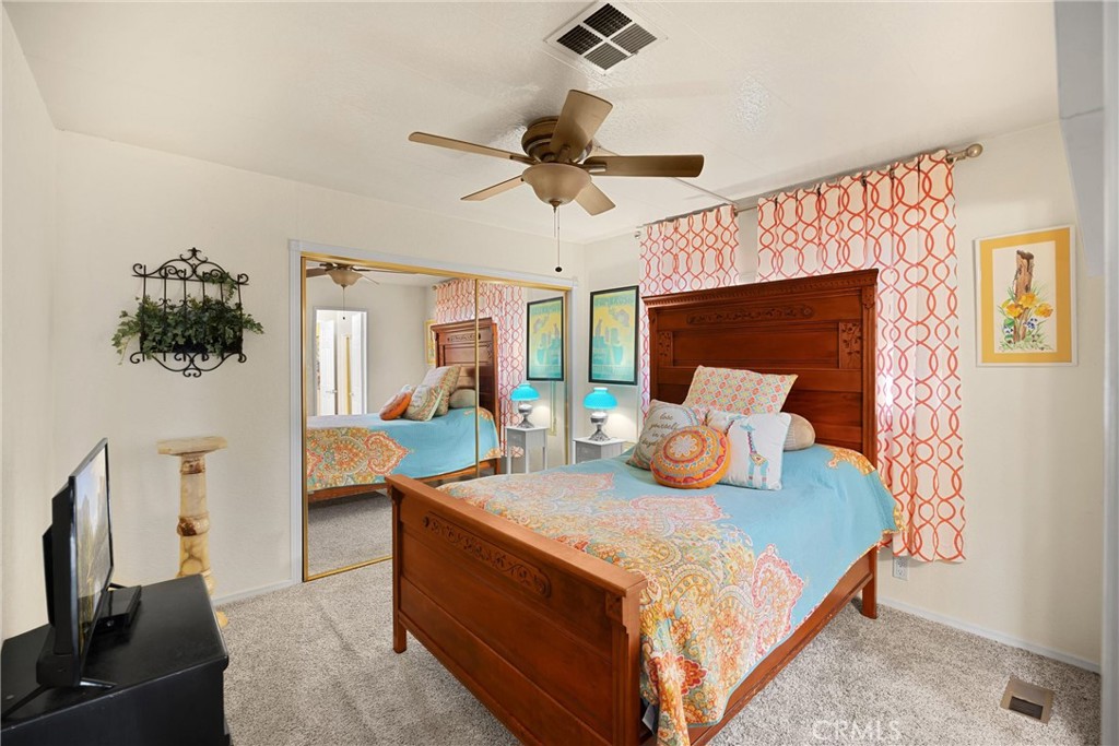 10210 Base Line Road, Unit 235 Rancho Cucamonga, CA 91701 - Photo 20 of 33 a bedroom with a bed and flat screen tv