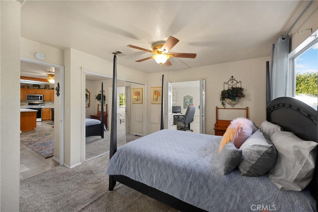10210 Base Line Road, Unit 235 Rancho Cucamonga, CA 91701 - Photo 22 of 33 a bedroom with a bed and a chandelier
